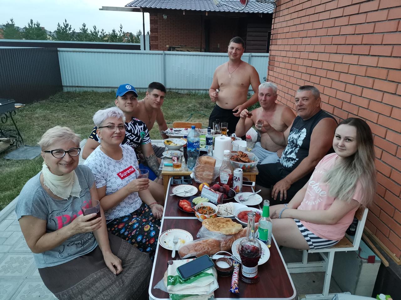 Семейный круг за большим столом во дворе